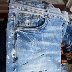 Amiri distressed jean with black and white paint splashes. Size 29/30